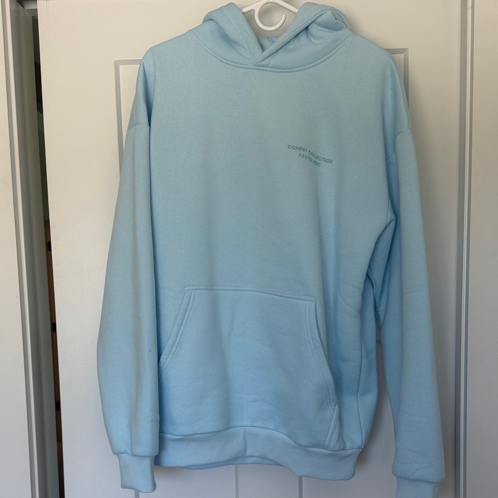 Light Blue Pullover Hoodie with Subtle Chest Text